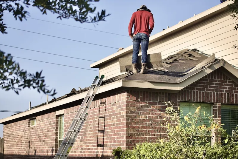 Professional roofer working on a residential roof in Pleasant Prairie